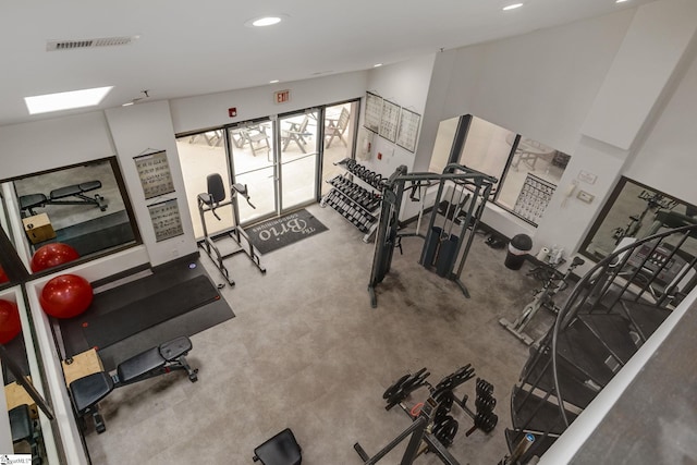 exercise room with visible vents and recessed lighting