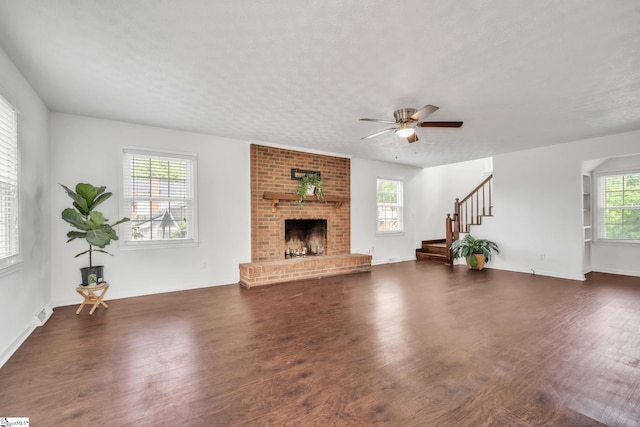 5 Huntley Castle Ct, Taylors, SC 29687 - unfurnished living room featuring a ceiling fan, baseboards, stairs, a brick fireplace, and wood finished floors