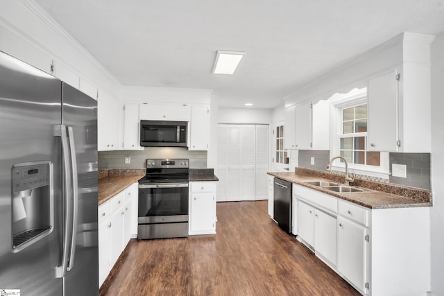 5 Huntley Castle Ct, Taylors, SC 29687 - kitchen featuring a sink, tasteful backsplash, dark wood-type flooring, white cabinets, and appliances with stainless steel finishes
