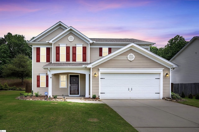 traditional-style house with concrete driveway, a garage, a front lawn, and fence