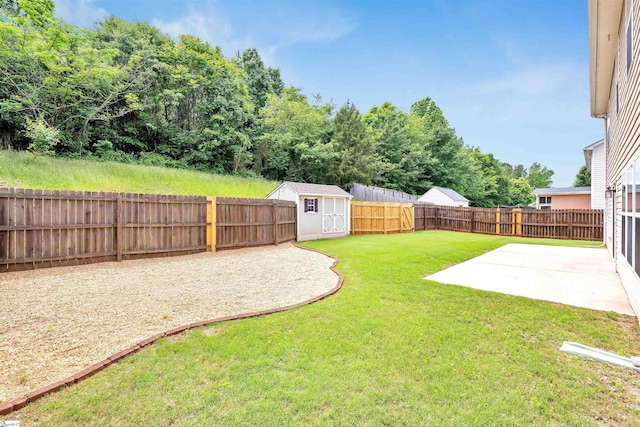 view of yard featuring a patio area, an outdoor structure, a fenced backyard, and a shed
