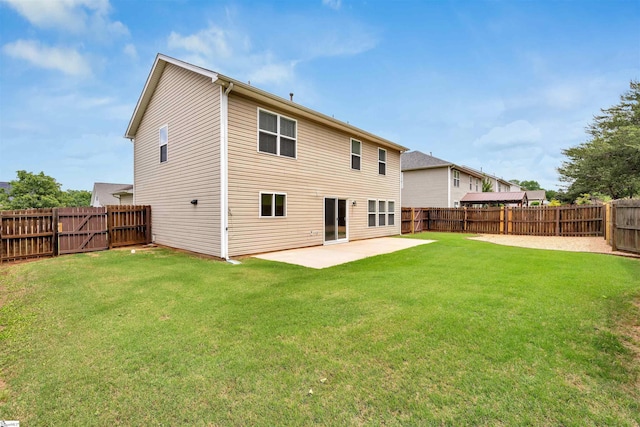 back of property with a yard, a patio, and a fenced backyard
