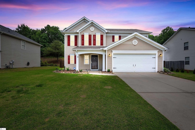 traditional-style house with concrete driveway, an attached garage, and a lawn