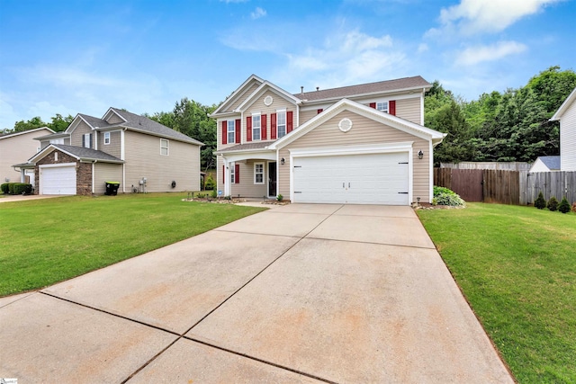 view of front of property with a front lawn, driveway, fence, and an attached garage