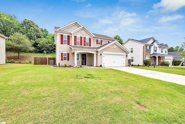 view of front of property with fence, a garage, a front lawn, and driveway