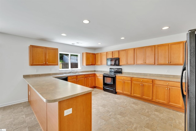 kitchen with a sink, a peninsula, black appliances, and recessed lighting