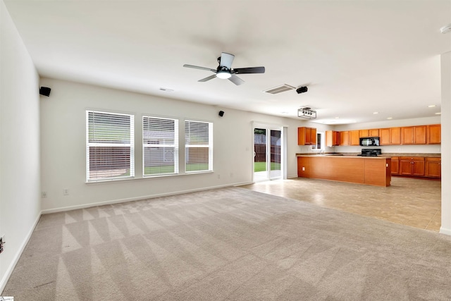 unfurnished living room featuring ceiling fan, light carpet, baseboards, and visible vents