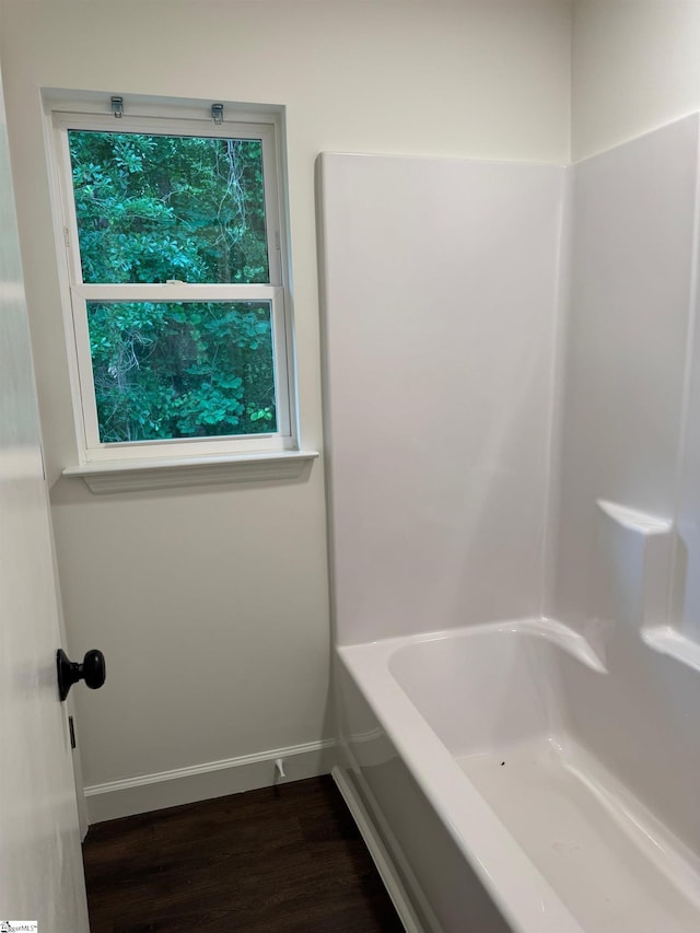 bathroom with baseboards and wood finished floors