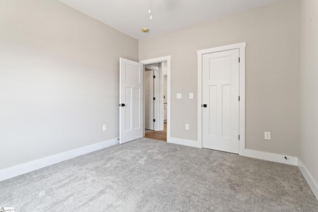 unfurnished bedroom featuring baseboards and carpet floors