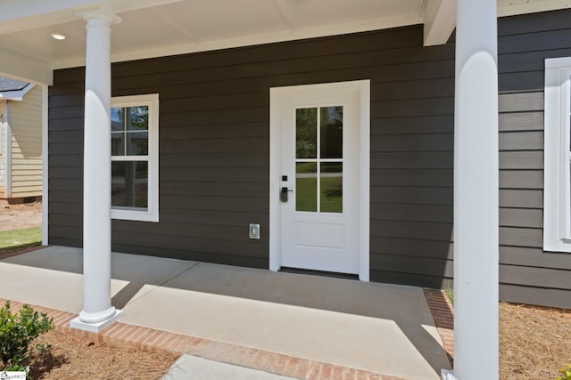 view of exterior entry with covered porch