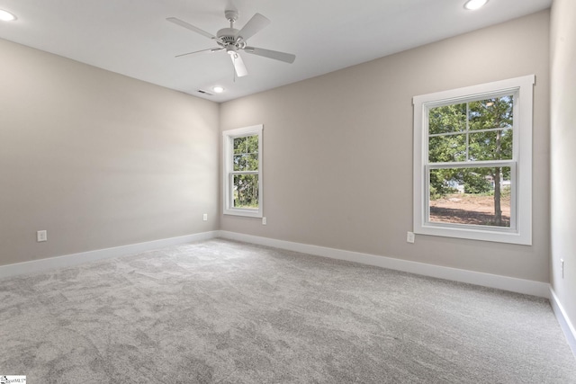 empty room featuring carpet floors, baseboards, a ceiling fan, and recessed lighting