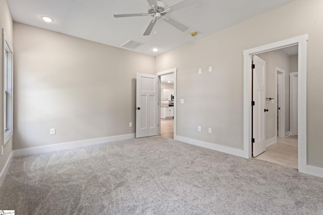 unfurnished bedroom featuring light carpet, baseboards, visible vents, and recessed lighting