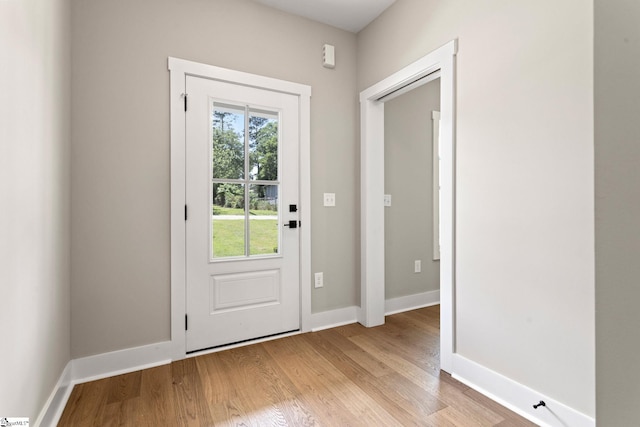 doorway to outside featuring light wood-style floors and baseboards