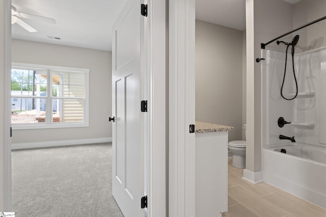 full bathroom featuring toilet, shower / washtub combination, visible vents, a ceiling fan, and baseboards