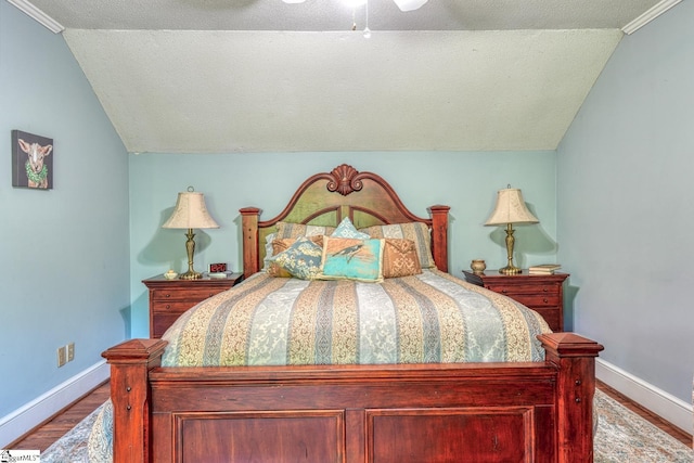 bedroom with lofted ceiling, baseboards, a ceiling fan, and wood finished floors