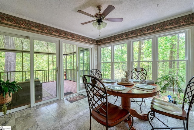 sunroom / solarium featuring a textured ceiling and french doors
