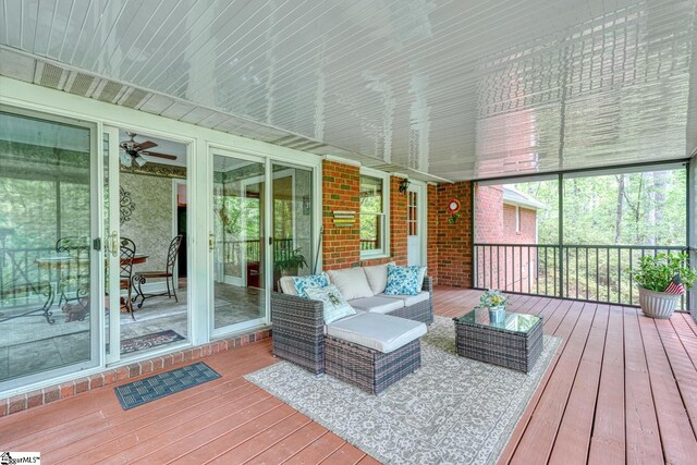 sunroom featuring an outdoor living space and ceiling fan