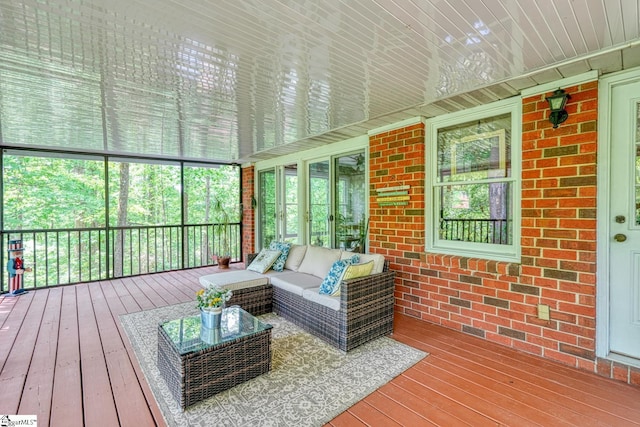 sunroom featuring an outdoor hangout area