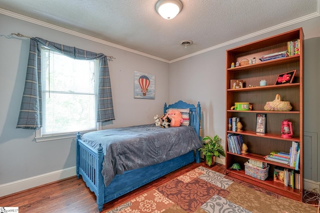 bedroom featuring crown molding, a textured ceiling, baseboards, and wood finished floors