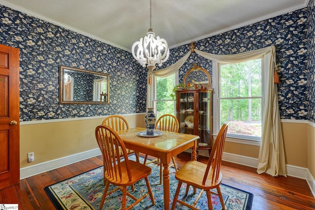 dining space featuring wallpapered walls, a healthy amount of sunlight, a chandelier, and wood-type flooring