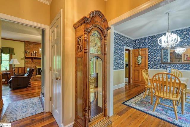 dining room featuring crown molding, hardwood / wood-style flooring, and a wainscoted wall