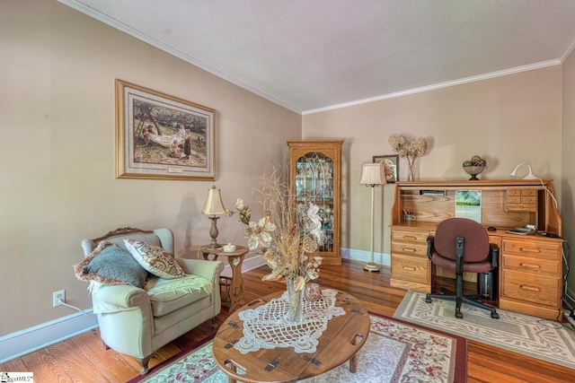 office space featuring crown molding, wood finished floors, and baseboards