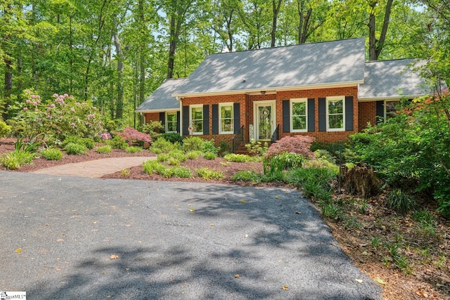 ranch-style home featuring brick siding