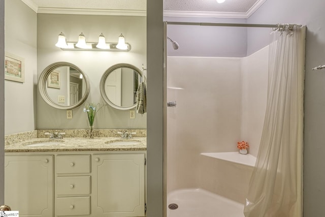 bathroom with double vanity, crown molding, a shower stall, and a sink