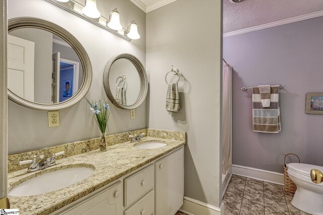 bathroom featuring a sink, ornamental molding, and toilet