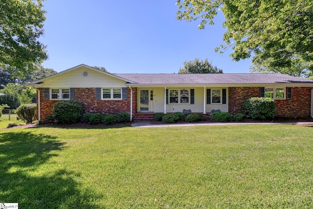 ranch-style home with brick siding and a front lawn