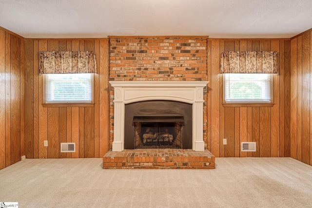 unfurnished living room featuring carpet floors, visible vents, and plenty of natural light