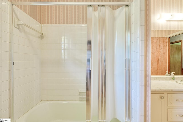 full bath with vanity and combined bath / shower with glass door