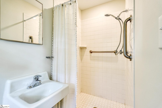 full bath with a shower stall and a sink