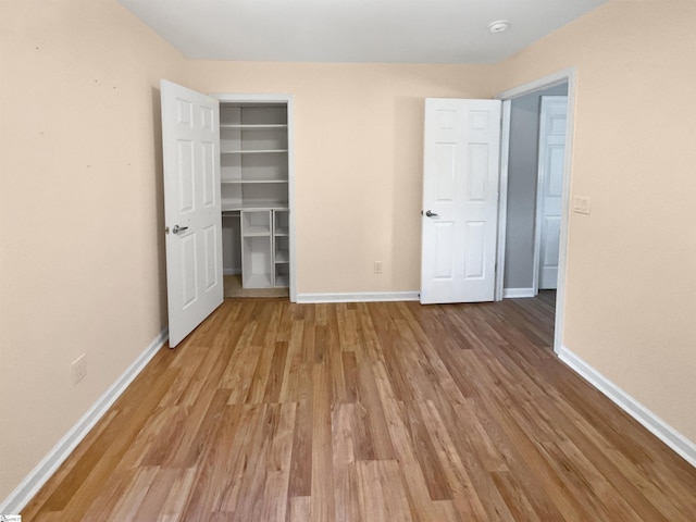 102 Thurber Way, Simpsonville, SC 29681 - unfurnished bedroom featuring a closet, light wood-style floors, baseboards, and a walk in closet