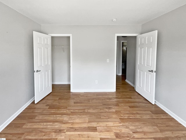 102 Thurber Way, Simpsonville, SC 29681 - unfurnished bedroom featuring baseboards, light wood-style floors, and a closet