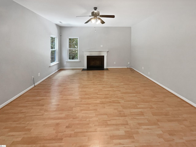 102 Thurber Way, Simpsonville, SC 29681 - unfurnished living room featuring a fireplace with flush hearth, light wood-style flooring, baseboards, and a ceiling fan