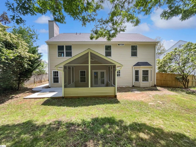 102 Thurber Way, Simpsonville, SC 29681 - back of property with a sunroom, a chimney, a lawn, and a fenced backyard