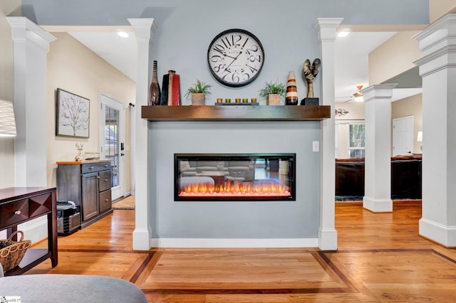 6 Shallow Creek Ct, Fountain Inn, SC 29644 - interior details with baseboards, a glass covered fireplace, decorative columns, and wood finished floors