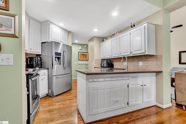6 Shallow Creek Ct, Fountain Inn, SC 29644 - kitchen featuring appliances with stainless steel finishes, a sink, a peninsula, white cabinets, and light wood-type flooring