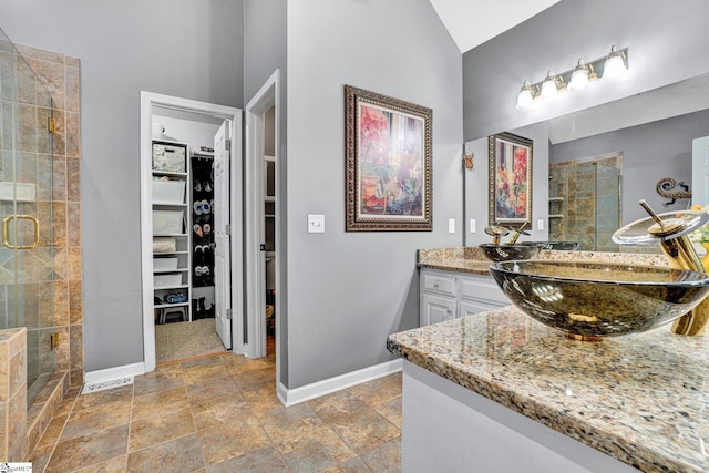 6 Shallow Creek Ct, Fountain Inn, SC 29644 - full bathroom with baseboards, a spacious closet, stone finish floor, and a stall shower