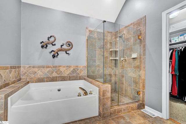 6 Shallow Creek Ct, Fountain Inn, SC 29644 - full bathroom featuring a walk in closet, a garden tub, lofted ceiling, and a stall shower