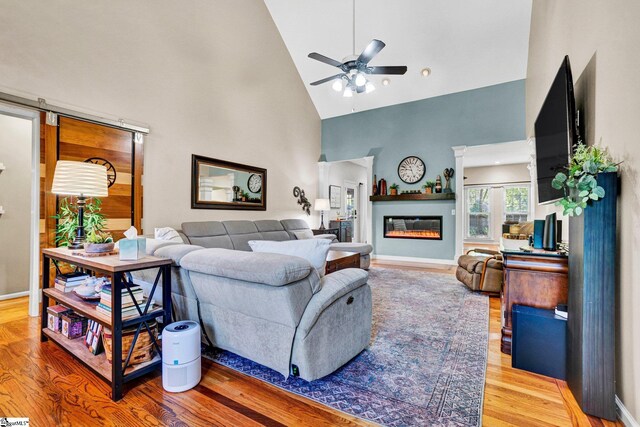 6 Shallow Creek Ct, Fountain Inn, SC 29644 - living room featuring wood finished floors, a ceiling fan, high vaulted ceiling, baseboards, and a glass covered fireplace