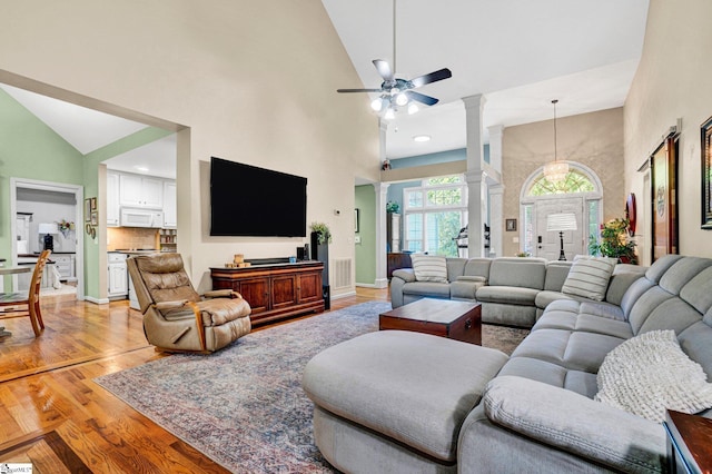 6 Shallow Creek Ct, Fountain Inn, SC 29644 - living area with light wood-style floors, high vaulted ceiling, a ceiling fan, and decorative columns