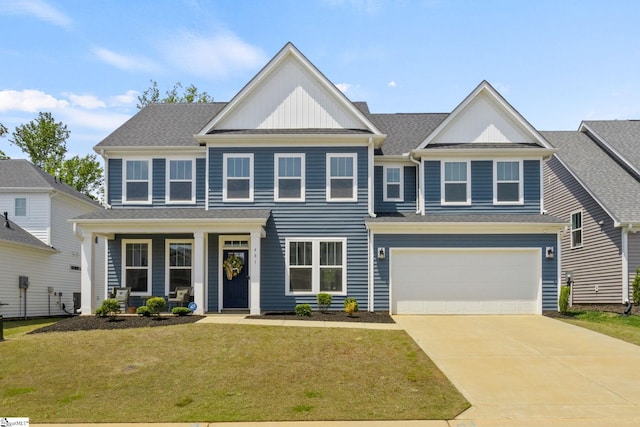 481 Fenwick Dr, Woodruff, SC 29388 - view of front facade featuring covered porch, an attached garage, concrete driveway, board and batten siding, and a front yard