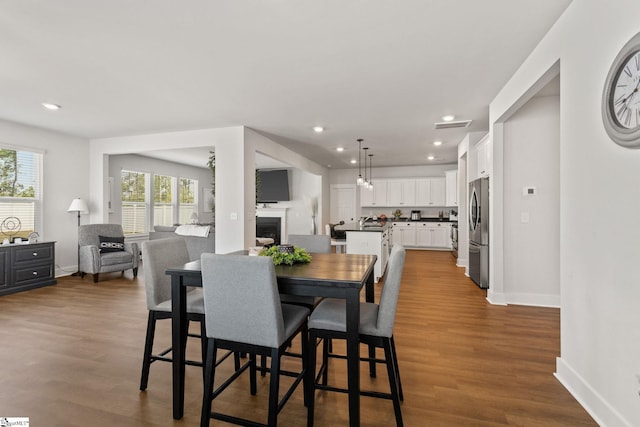 481 Fenwick Dr, Woodruff, SC 29388 - dining space with baseboards, dark wood-style floors, visible vents, and plenty of natural light