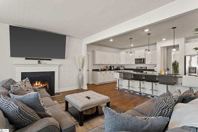 481 Fenwick Dr, Woodruff, SC 29388 - living area featuring dark wood-style flooring, baseboards, a fireplace with flush hearth, and recessed lighting