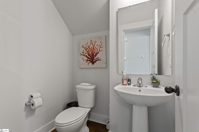 481 Fenwick Dr, Woodruff, SC 29388 - bathroom featuring vaulted ceiling, toilet, a sink, and baseboards