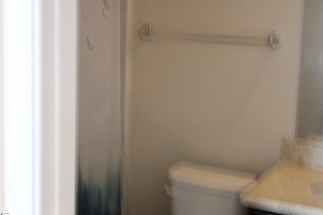 bathroom with toilet and vanity