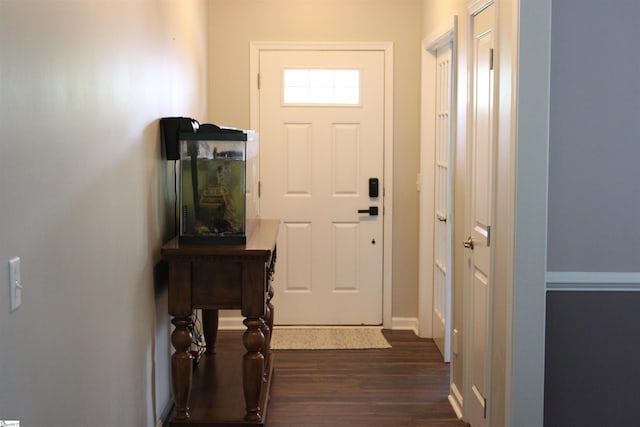 doorway with baseboards and dark wood-style flooring