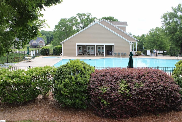 community pool featuring a patio area and fence